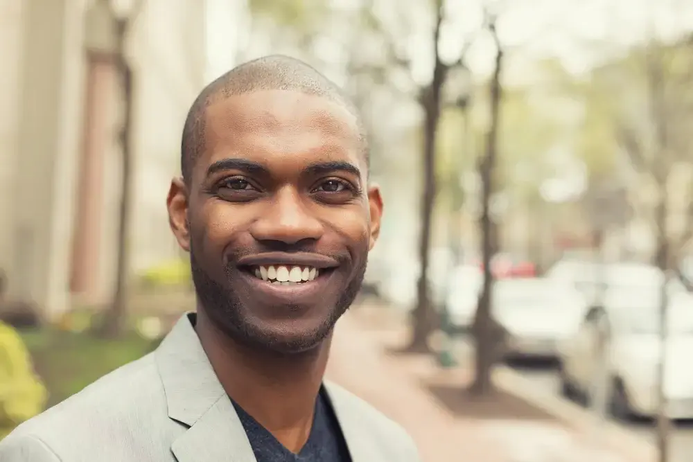 Headshot portrait of young man smiling isolated on outside outdoors background. Headshot portrait of young man smiling isolated on outside outdoors background.