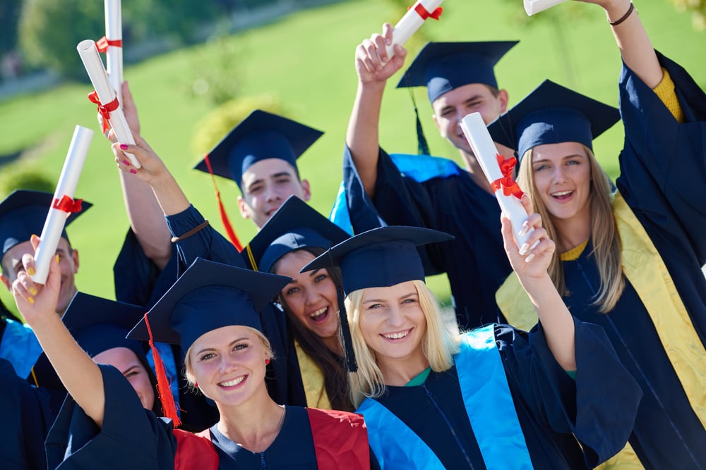 young graduates students group  standing in front of university building on graduation day-1